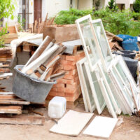 Yard with construction materials laying in disarray.