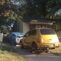 junk vehicles parked out in house driveway